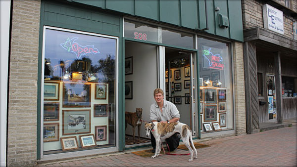 David Black pictured in front of his store with his Greyhounds