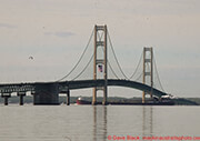 Mackinac Bridge with flag and freighter
